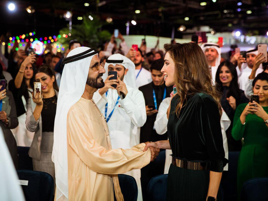 Media crew interviewing attendees with the Dubai skyline behind them